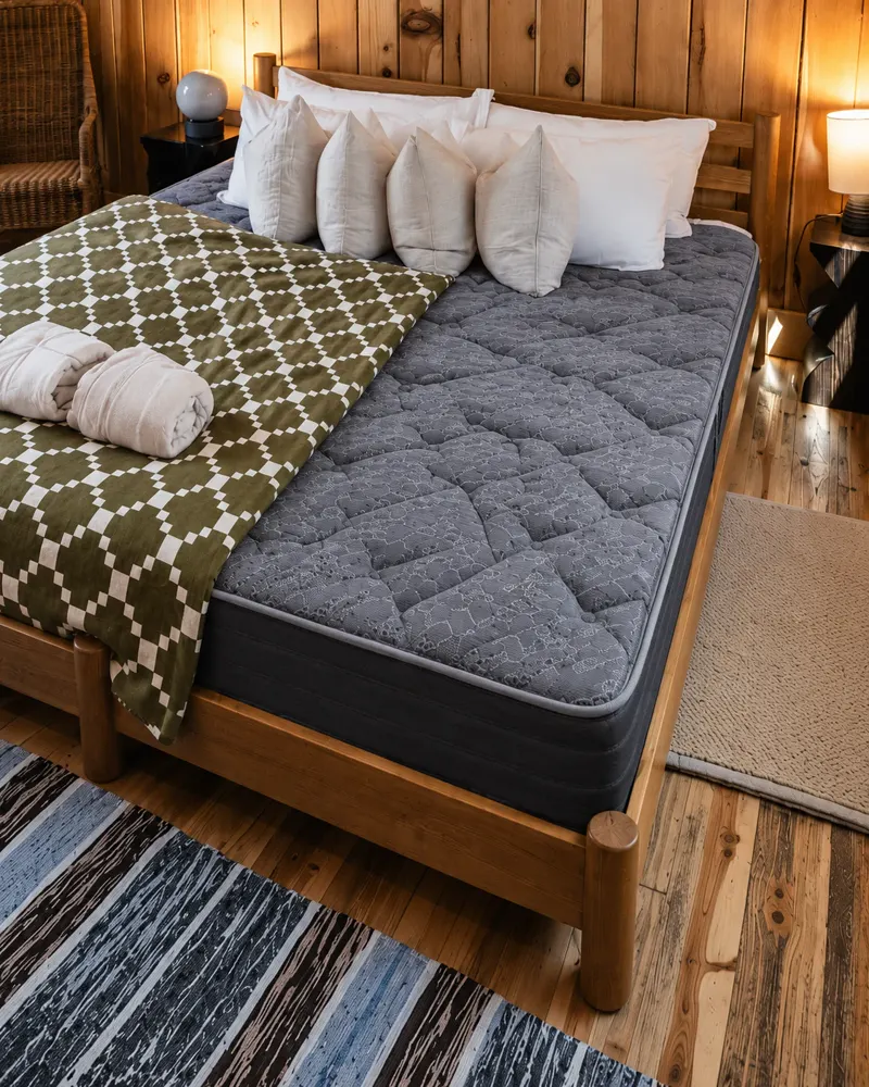 King mattress in a warm wood bedroom, seen from above the bed